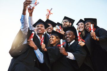 Sharing a special day with friends and family online. a group of students taking a selfie on...
