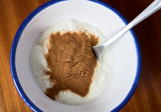 Healthy snack. Bowl with yogurt and cinnamon