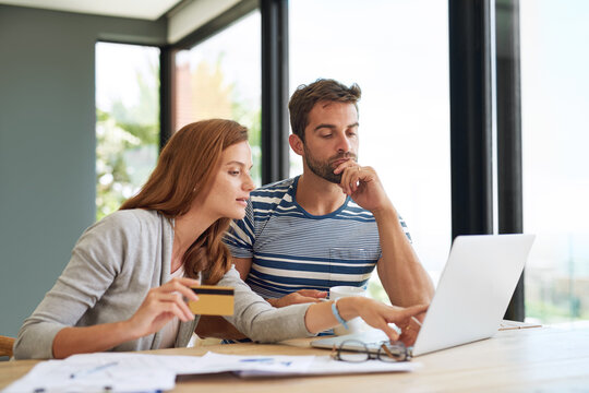 Which one do you like best. a young couple working on their household budget and paying bills online.