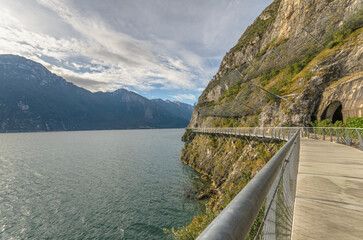 "Ciclopista del Garda" - Bicycle road and foot path over Garda lake with beautiful landscape scenery at Limone Sul Garda - travel destination in Brescia, Italy