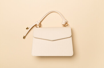 Fashionable leather bag on color background, top view
