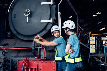 Team of engineer railway wearing safety uniform and helmet under checking under train ,wheels and control system for safety travel passenger. Maintenance cycle concept.