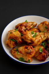 Homemade Grilled Chicken Wings with Parsley on a Plate, side view.