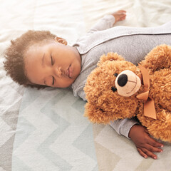 Sleeping, teddy bear and cute with baby in bedroom for carefree, development and innocence. Dreaming, relax and comfortable with african infant and toy at home for morning, resting and bedtime