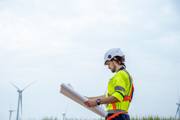Engineer checking control electric power at windmill farm,Generating electricity clean energy.
