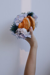 Fresh delicious croissant with flowers inside  - 599551978