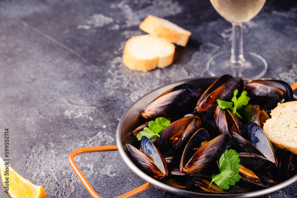 Wall mural delicious seafood mussels with sauce and parsley.