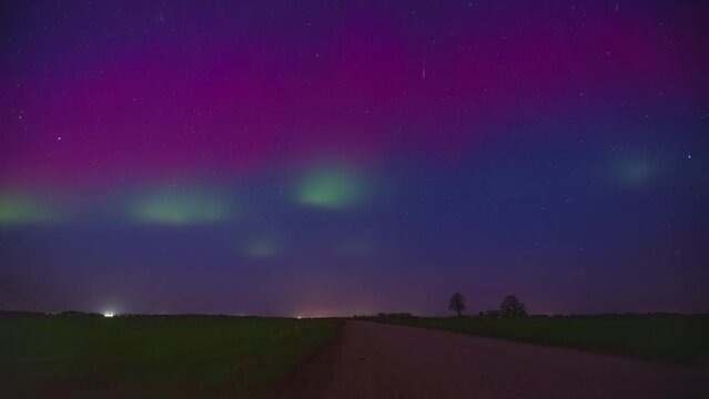 Colorful Aurora Borealis Over The Sky Of A Countryside Road. 