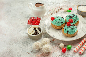 front view colorful candies with cream cakes on white background biscuit sweet cake cookies