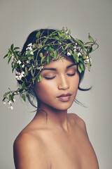 Beauty, flowers and crown with a woman in studio on a gray background for natural skincare or...
