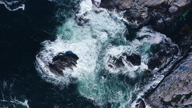 Topdown aerial shot of messy waters. Swells hitting the reefs.