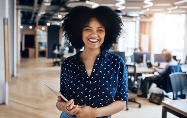 Welcome to the team, let me introduce you to everyone. Portrait of an attractive young female designer holding a digital tablet and in good spirits at the office.