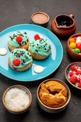 front view delicious creamy cakes with candies on dark background candy biscuit cake dessert cookie color