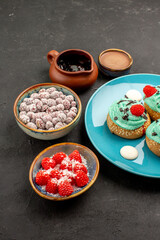 front view delicious creamy cakes with candies on dark desk dessert cake biscuit candy cookie color