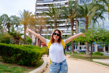 Fototapeta premium Happy traveler girl sightsees the city of Alicante Spain. lifestyle concept