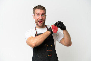 Butcher caucasian man wearing an apron and serving fresh cut meat isolated on white background celebrating a victory