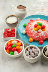 front view delicious pink cake with colored candies on white background color dessert cookie candy cake rainbow