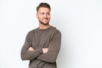 Young blonde caucasian man isolated on white background looking to the side and smiling