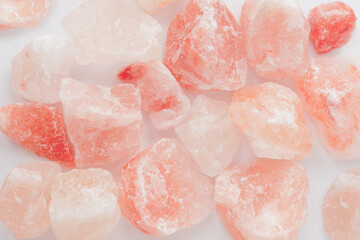 Raw rose quartz crystal stones on white