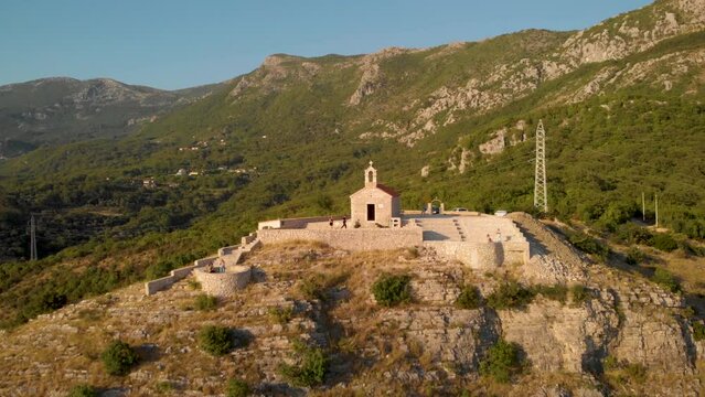 Tourists Traveling Around The Church Of Saint Sava On Hilltop During Daytime In Montenegro. aerial