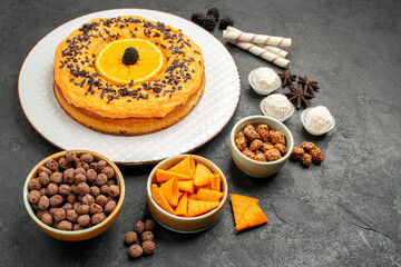front view delicious sweet pie with orange slices on dark-grey background dough fruit pie cake biscuit