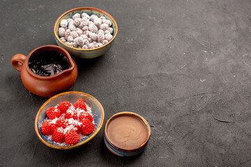 front view different candies with chocolate syrup on dark grey background color candy tea biscuit