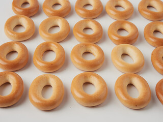 Tasty dry bagels (sushki) isolated on white, top view