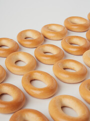 Tasty dry bagels (sushki) isolated on white, top view