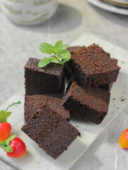 Slices of Brownies Kukus or steamed brownies or rich chocolate cake on white tray