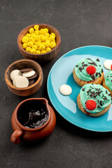 front view little creamy cakes with candies on dark grey background dessert cake biscuit candy cookie color
