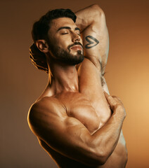 Beauty, body fitness and man in studio isolated on a brown background. Eyes closed, exercise and...