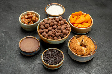 front view sweet nuts with cocoa flakes and cips on dark background snack milk meal breakfast color