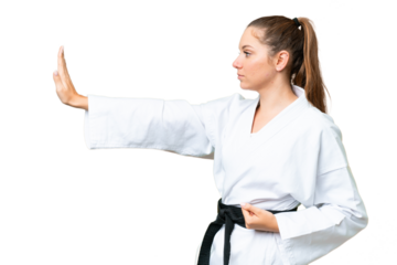 Young blonde woman over isolated chroma key background doing karate