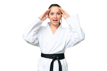 Young blonde woman doing karate over isolated chroma key background with surprise expression