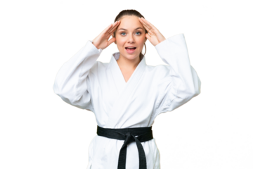 Young blonde woman doing karate over isolated chroma key background with surprise expression