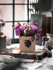 Beautiful artificial purple flower on the table. Conceptual stilllife photograpy