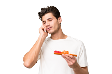 Young caucasian man holding sashimi over isolated background with headache