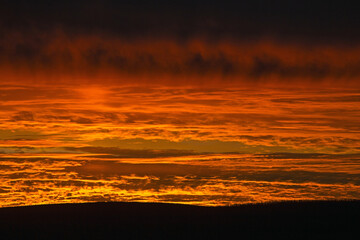 Beautiful clouds in the sunset light. Abstract composition of dramatic sky.