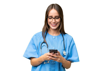 Young nurse caucasian woman over isolated background sending a message with the mobile