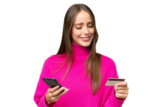 Young beautiful caucasian woman over isolated background buying with the mobile with a credit card