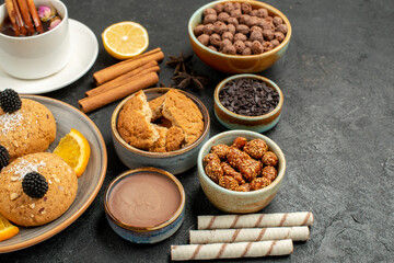 front view yummy cookies with cup of tea on the dark grey background cake pie dessert biscuit tea cookie