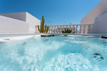 Panoramic view above the water level of a modern outdoor jacuzzi bathtub for leisure tourists.