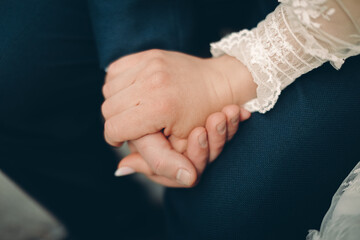 close up of a couple holding hands together