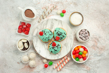 top view colorful candies with cream cakes on white background biscuit sweet cake tea cookie