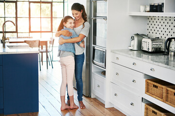 Meaningful moments with mom. Portrait of a happy mother and daughter in a loving embrace at home.