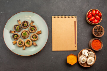 top view cooked mushrooms with seasonings and tomatoes on dark desk dish meal cooking mushrooms dinner