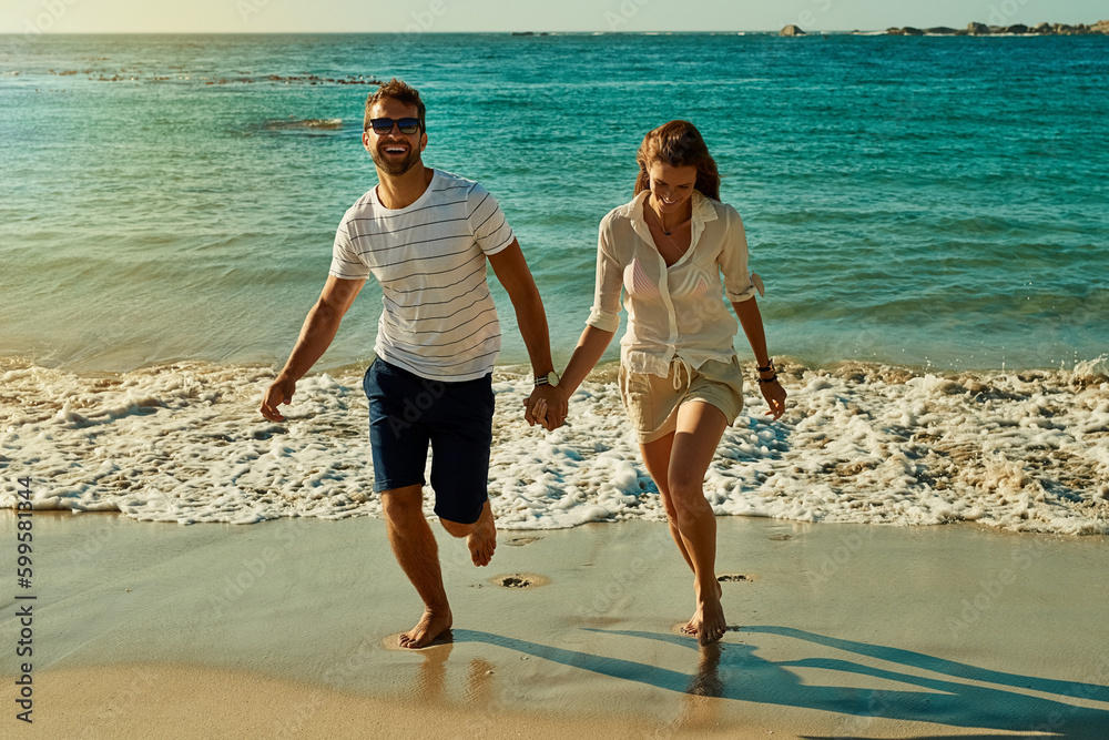 Canvas Prints Its not summer until you get your feet wet. a happy young couple running along the beach.