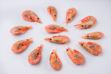 Frozen shrimps in ice with caviar on a white background. A lot of royal shrimp close-up.