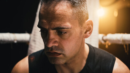 tired boxer sitting at ringside