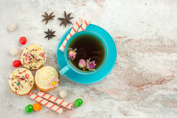 Fototapeta na wymiar top view cup of tea with candies and cakes on white background tea dessert biscuit cake pie